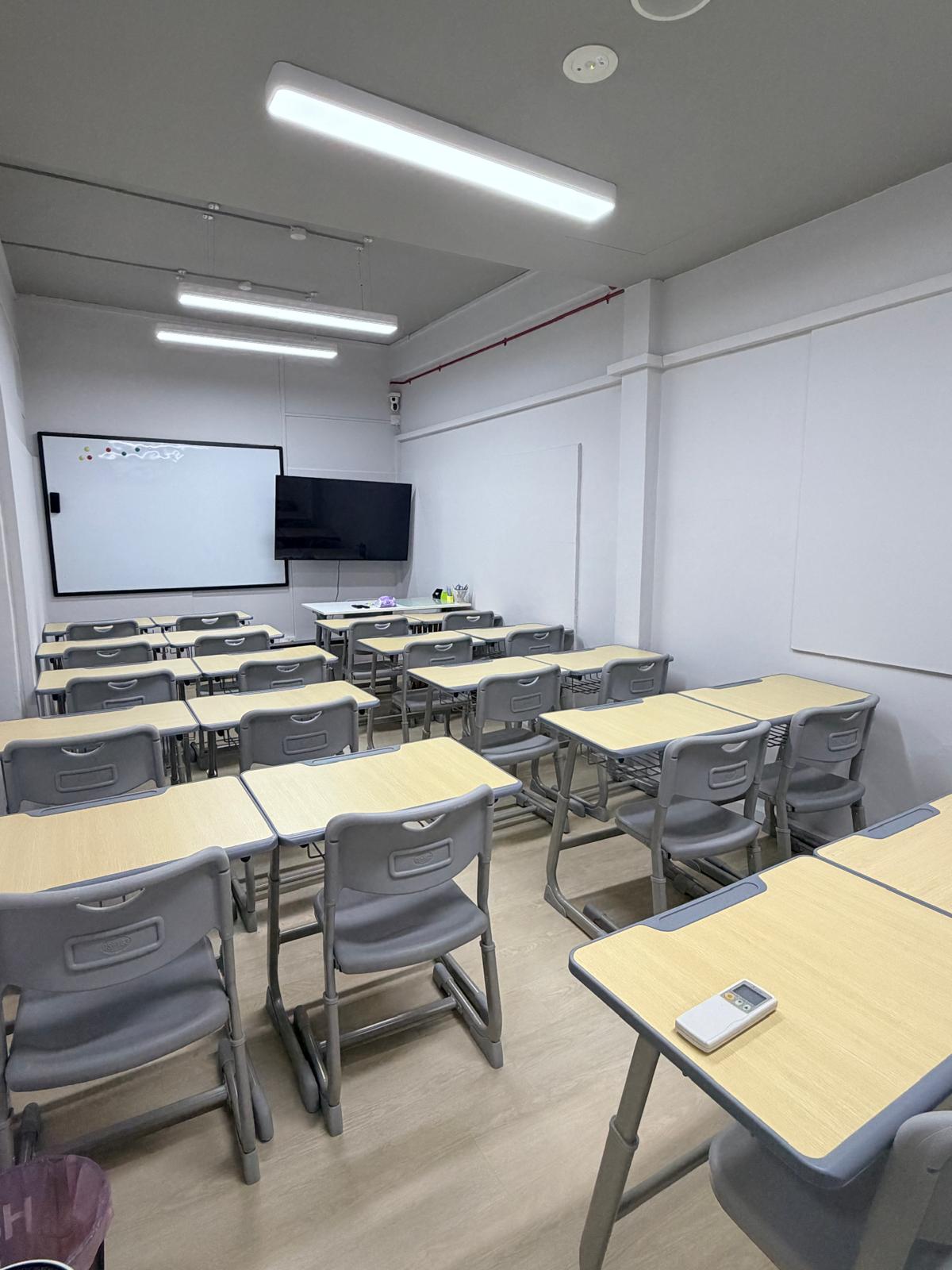 A classroom set up with whiteboard and projector