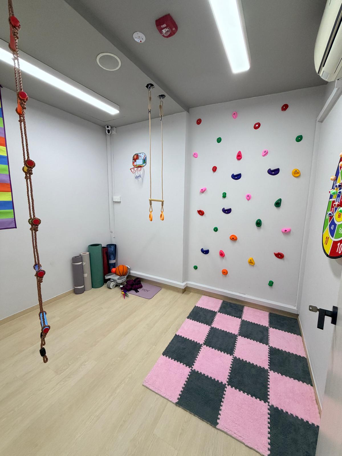 A colourful play corner with a climbing wall
